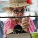 Kathleen Cohen, of San Fransisco, gets a closer look at a necklace at the In the Beginning booth on S. Thompson St. on Wednesday, July 17, 2013. Melanie Maxwell | AnnArbor.com